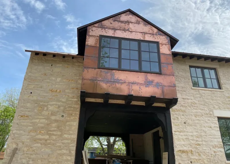 Copper metal panel facade on a stone building for Skylight Installation in Orchard Mesa